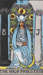 The High Priestess tarot card features a woman in flowing garments, seated between two pillars adorned with symbols, representing intuition, mystery, and inner wisdom.