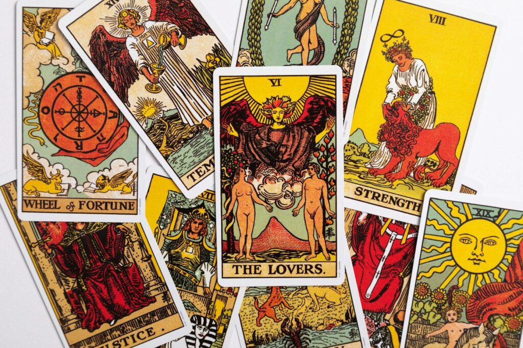 Rider-Waite-Smith Major Arcana cards scattered together, including The Lovers, Wheel of Fortune, Strength and The Sun